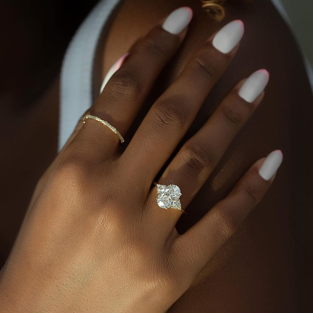 Oval Moissanite Trio Cluster Accent Solitaire Ring on hand in 14K Gold