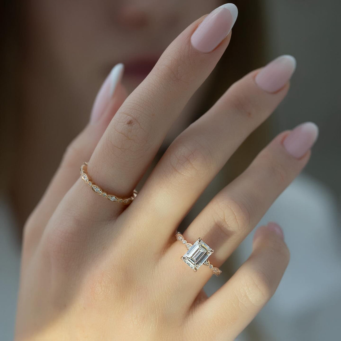 Emerald Cut Moissanite Vintage Milgrain Solitaire Ring on hand in 14K Gold