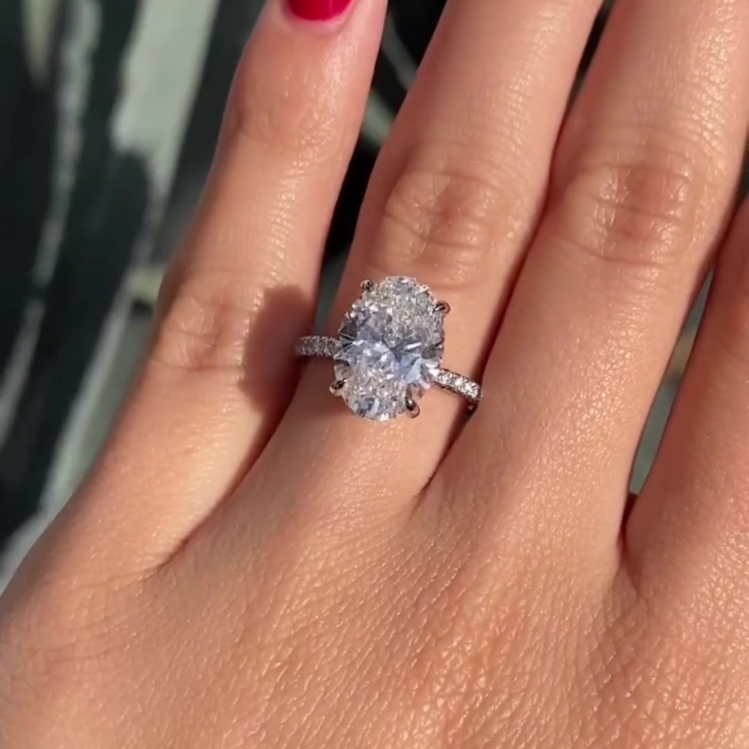 Oval cut moissanite engagement ring with hidden halo in solid gold