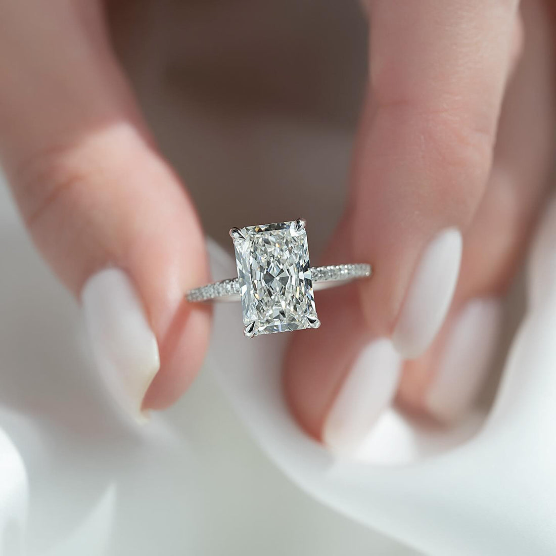 Radiant cut moissanite ring with hidden halo and slim pave band in 14K white gold