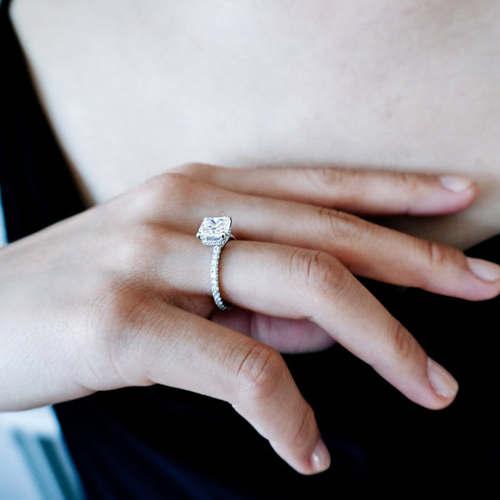 Cushion hidden halo pave band ring on the finger