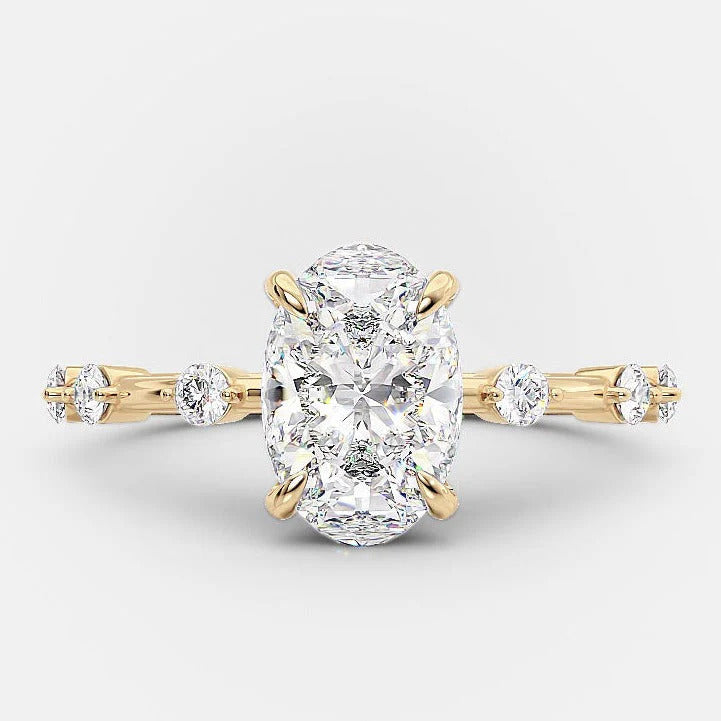 Oval cut moissanite engagement ring with distance pave band in gold