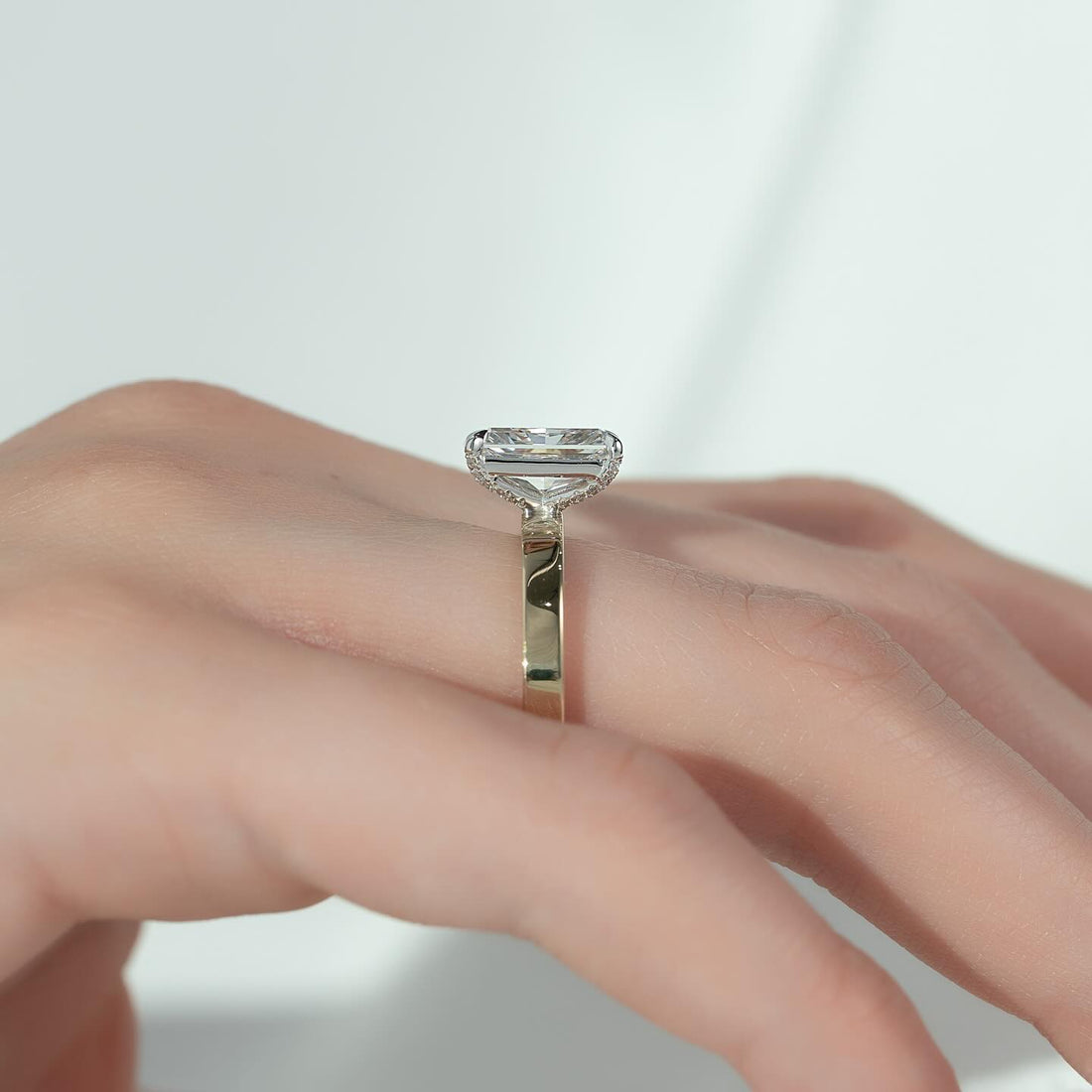 Radiant cut moissanite hidden halo flat band ring side view showing hidden halo