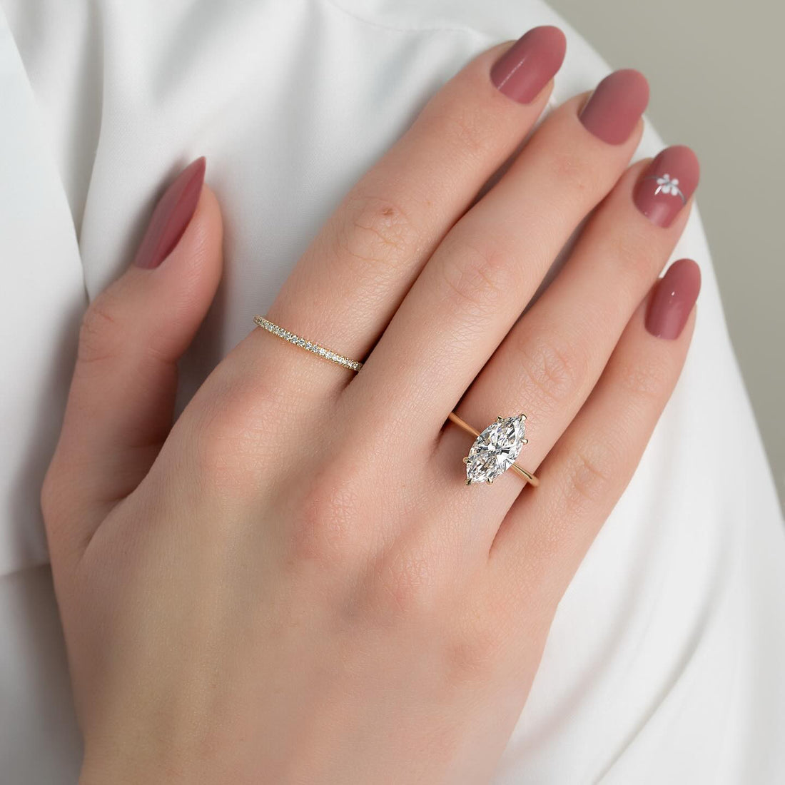 Marquise cut moissanite hidden halo pave ring in 14K yellow gold on hand