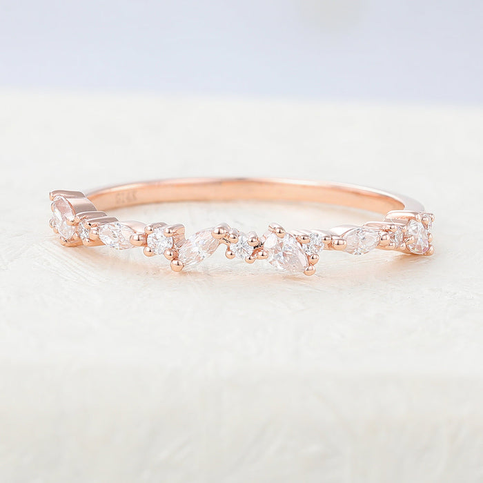 Rose gold multi stone moissanite band with marquise, pear and round stones, front view