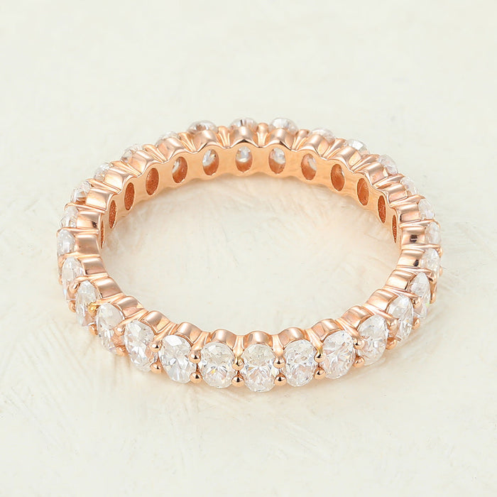 Oval moissanite full eternity wedding band in rose gold with a circle of prong set ovals