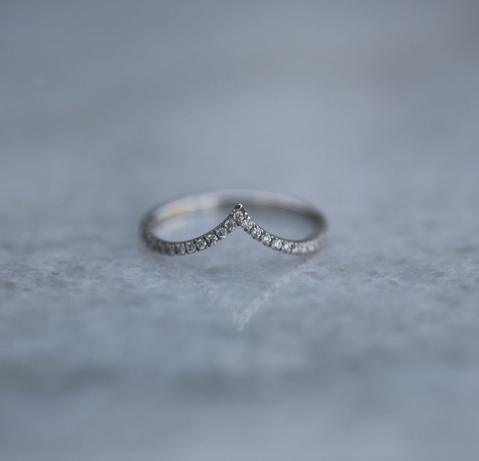 Curved V shaped pave moissanite wedding band in white gold, front view