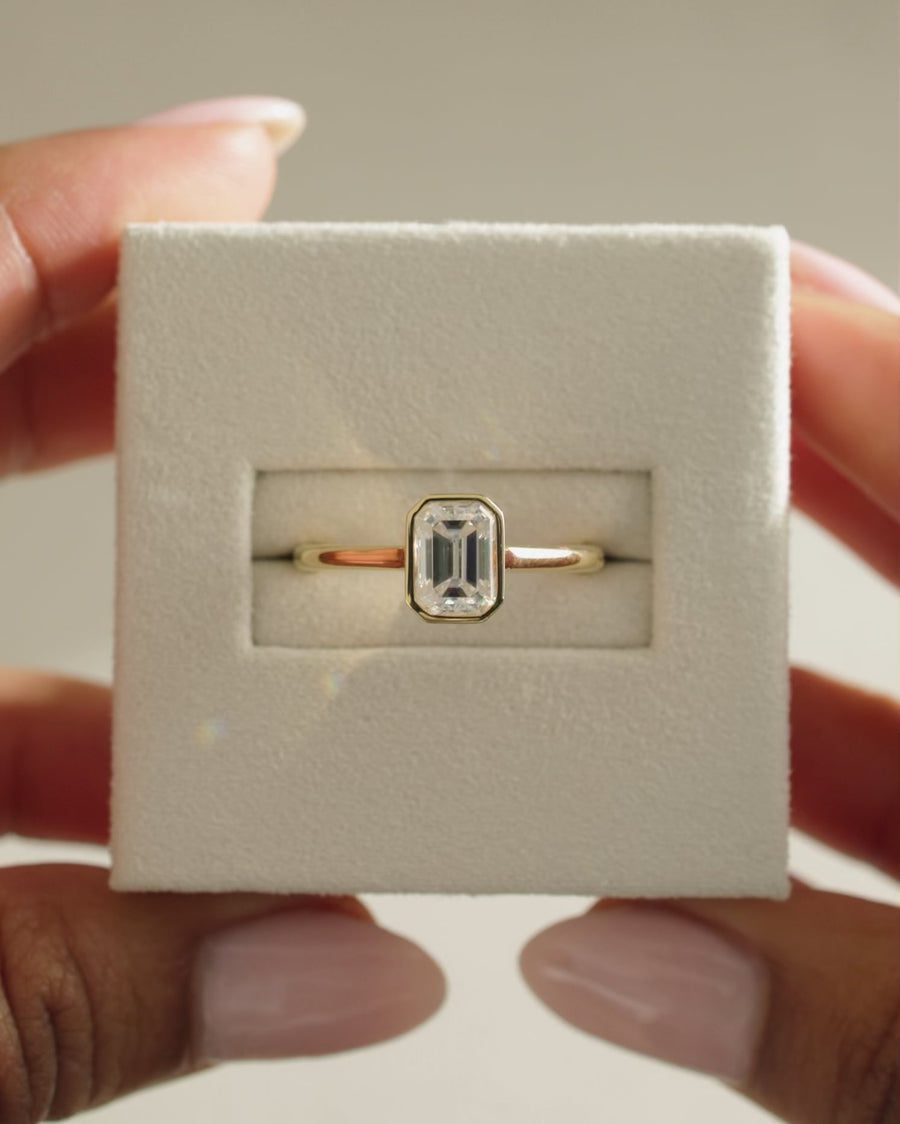 Emerald Cut Moissanite Bezel Set Solitaire Engagement Ring with Slim Band - view 1