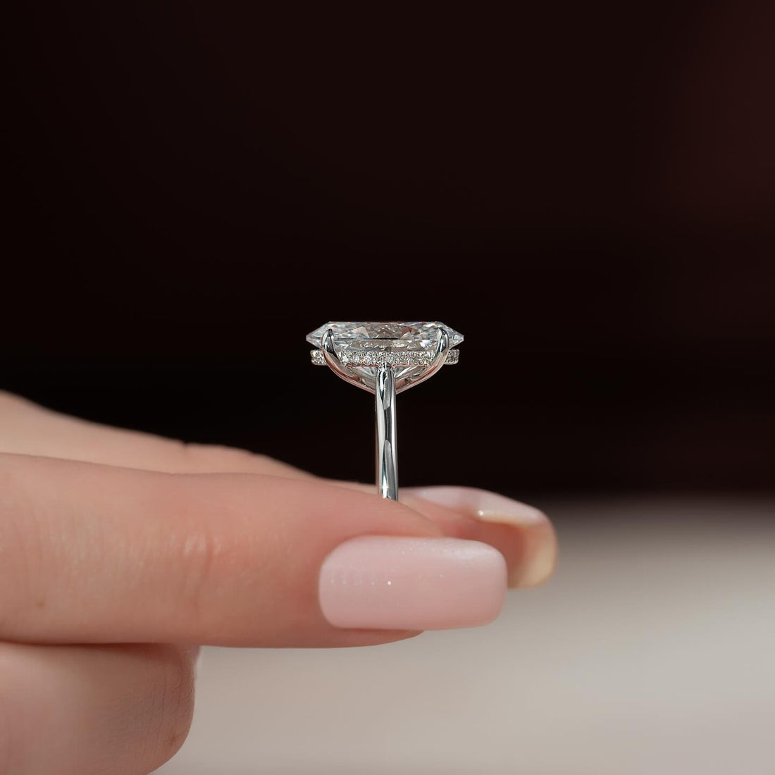 Oval cut moissanite hidden halo cathedral ring side profile in 14K white gold