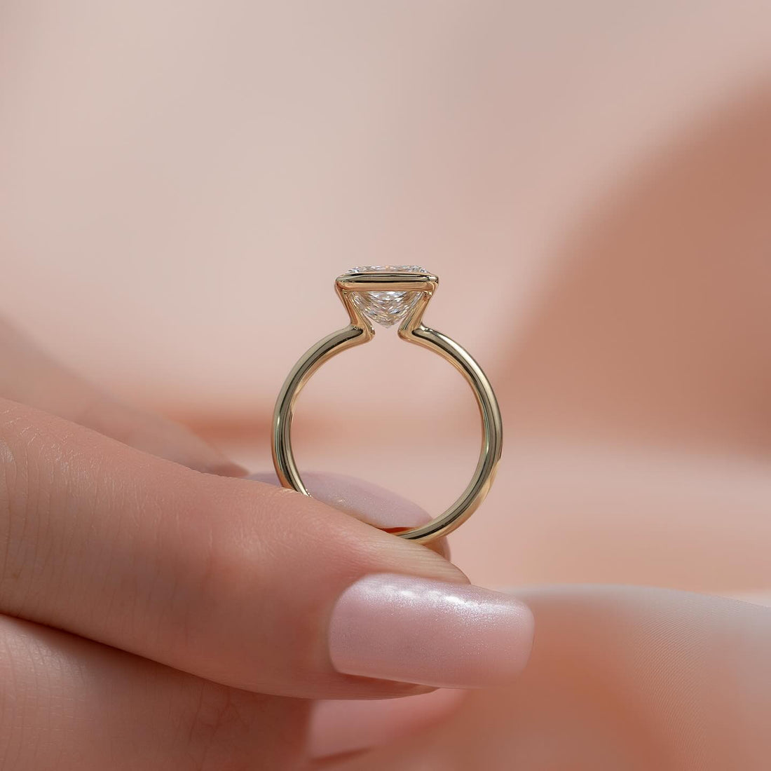 Princess cut moissanite half bezel thin band ring side profile in 14K yellow gold