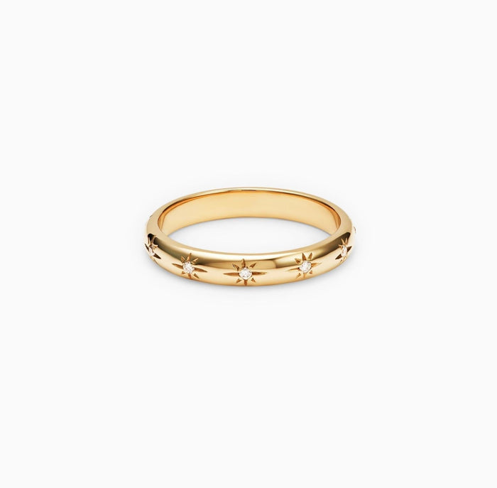 Round starburst flush set moissanite wedding band in yellow gold, front view