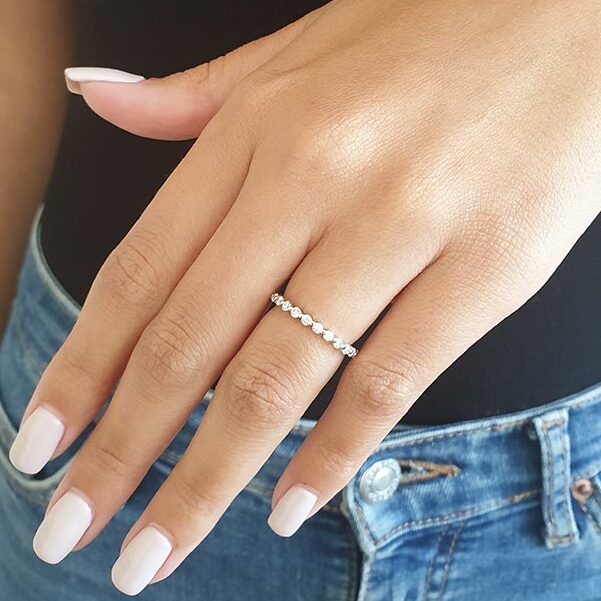 Round lab grown diamond full eternity wedding band on hand