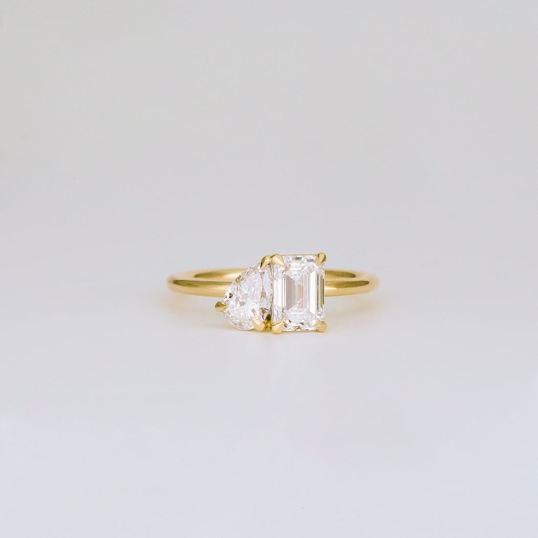 Emerald and half moon cut lab grown diamond toi et moi ring in yellow gold