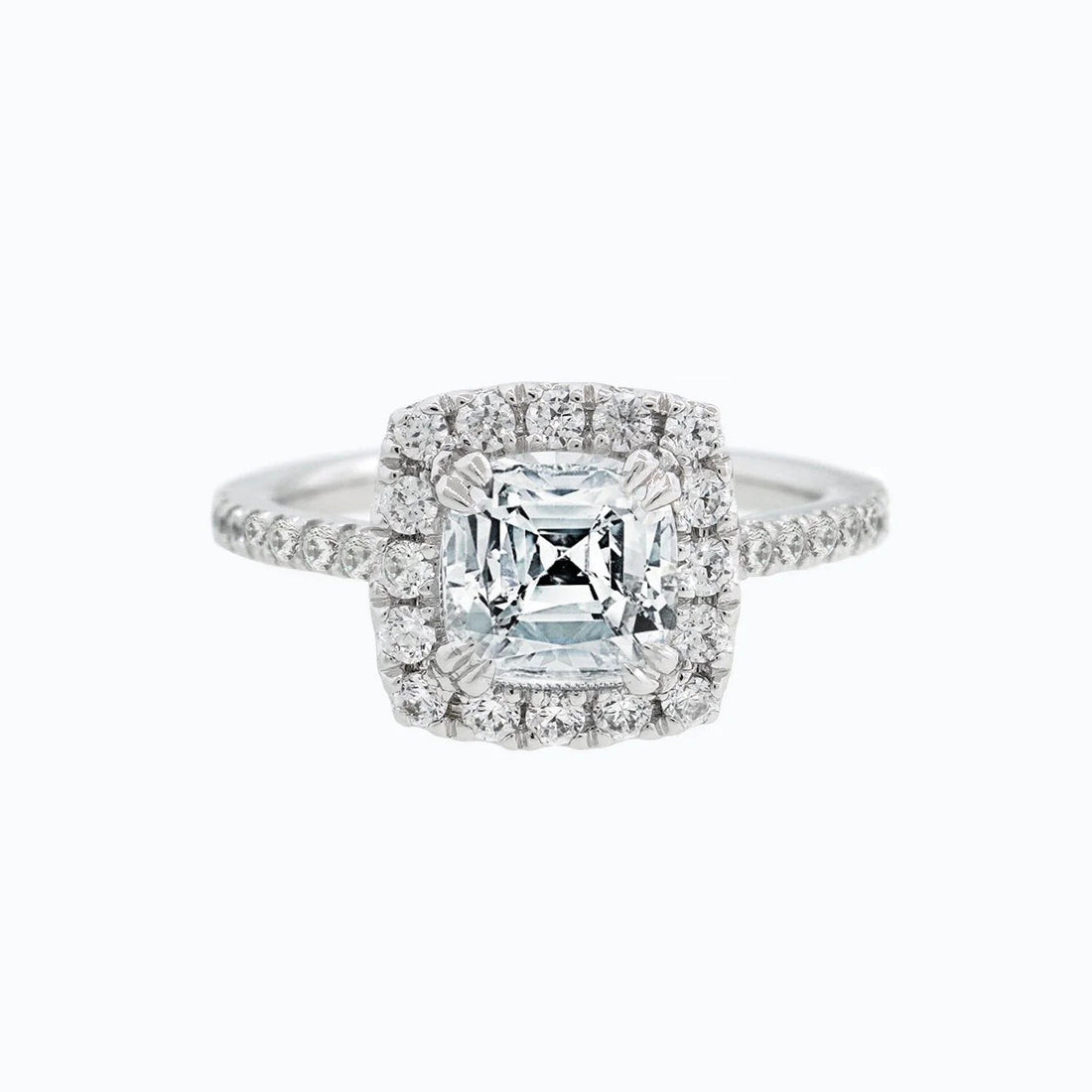 Cushion cut moissanite double halo engagement ring set in gold