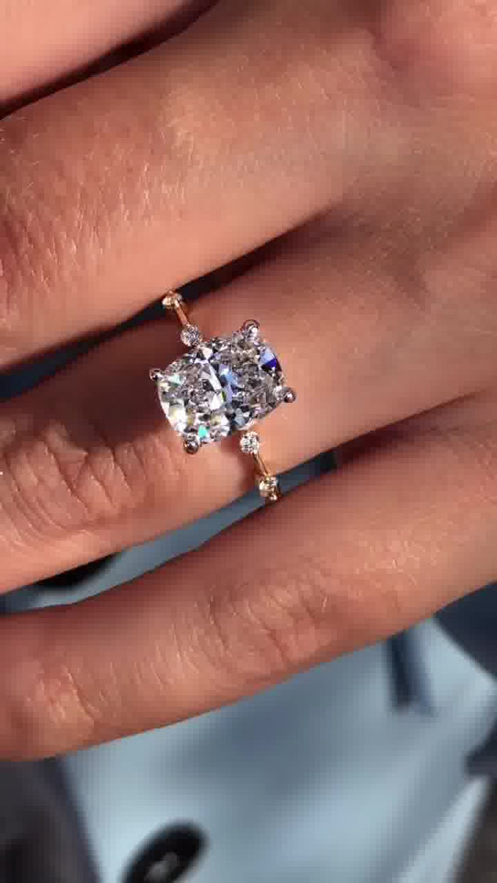 Elongated cushion cut moissanite engagement ring with distance pave diamonds in gold