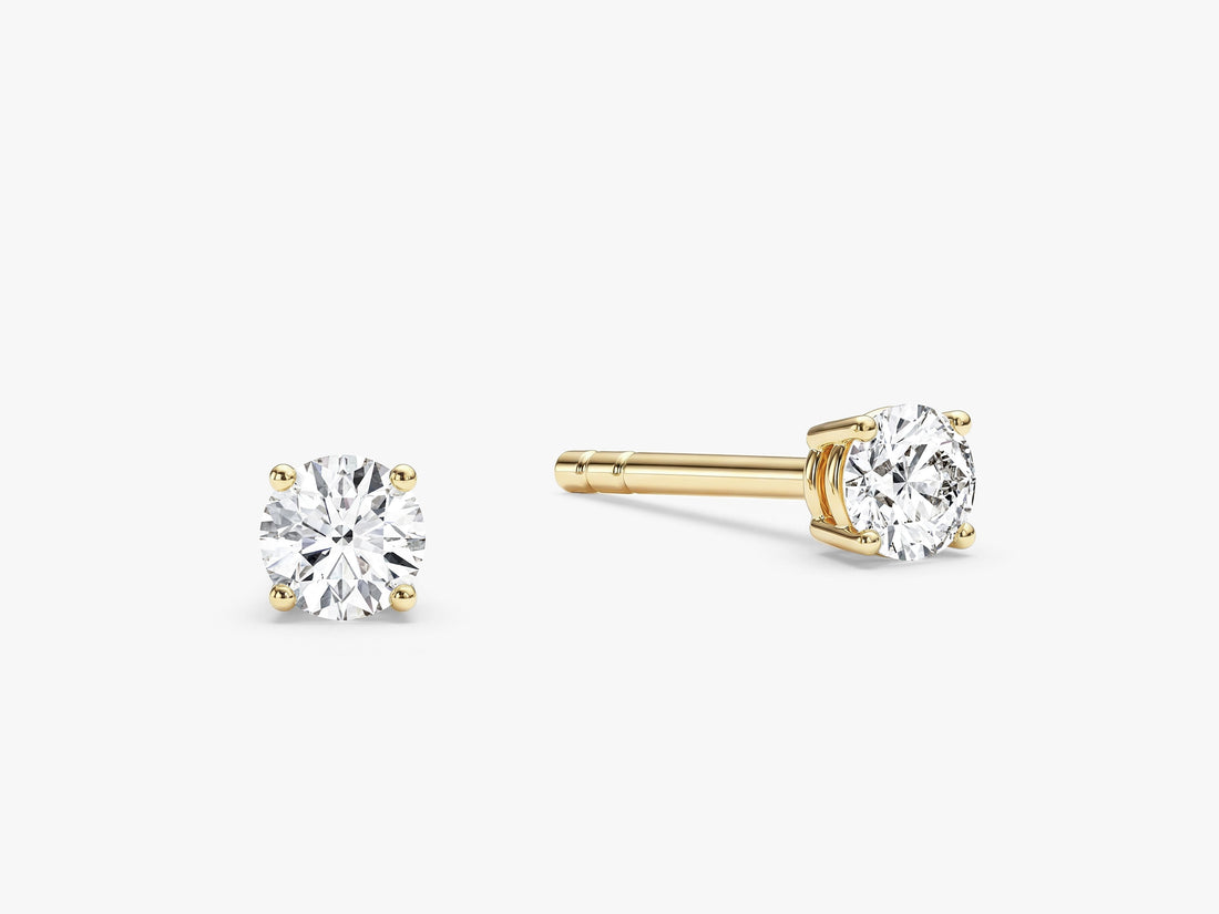 Pair of round cut moissanite solitaire stud earrings in yellow gold