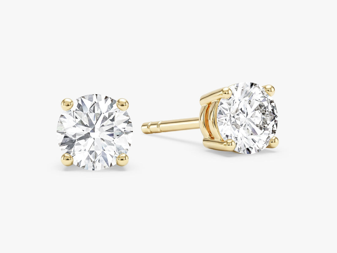 Pair of four prong round brilliant moissanite stud earrings in yellow gold