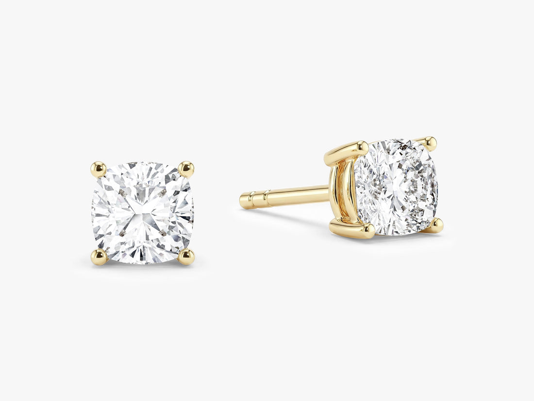 Pair of cushion cut moissanite solitaire stud earrings in yellow gold