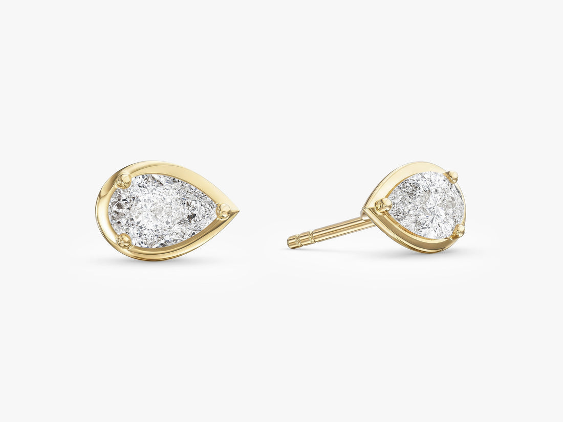 Pair of pear bezel set moissanite solitaire stud earrings in yellow gold