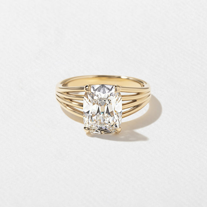 Elongated cushion cut lab grown diamond ring on a ribbed multi rail shank in yellow gold
