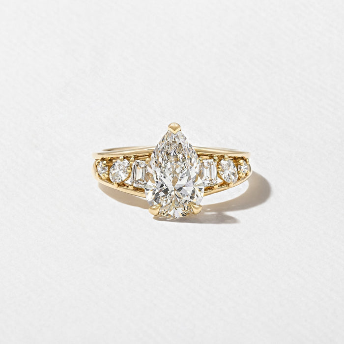 Pear cut lab grown diamond ring with cluster set shoulders in yellow gold