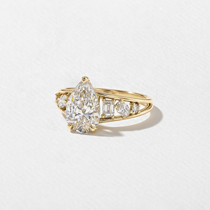 Angled view of the pear cut lab grown diamond and clustered shoulders