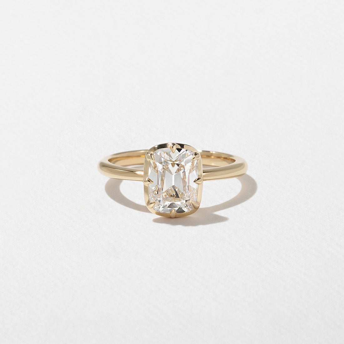Antique cushion cut lab grown diamond solitaire engagement ring with a decorative gallery in yellow gold