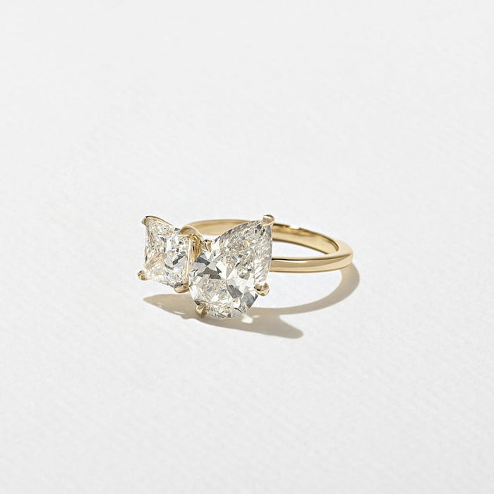 Pear and princess cut lab grown diamond toi et moi engagement ring in yellow gold