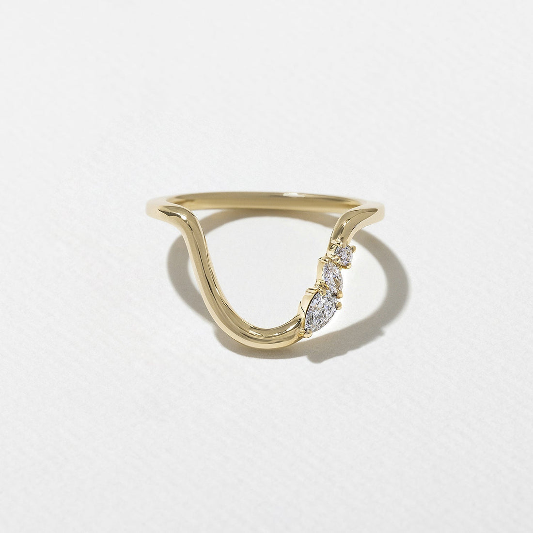 Curved three stone lab grown diamond wedding band in yellow gold