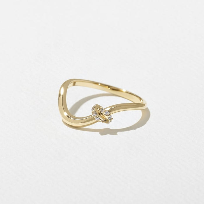 Side view of the curved knot band with tiny moissanite stones