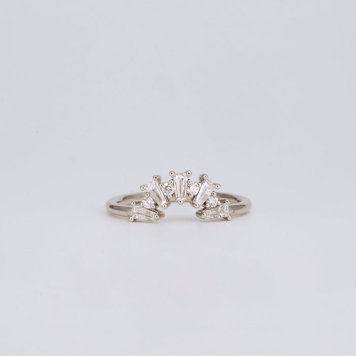 Curved moissanite wedding band with tapered baguette stones in white gold front view