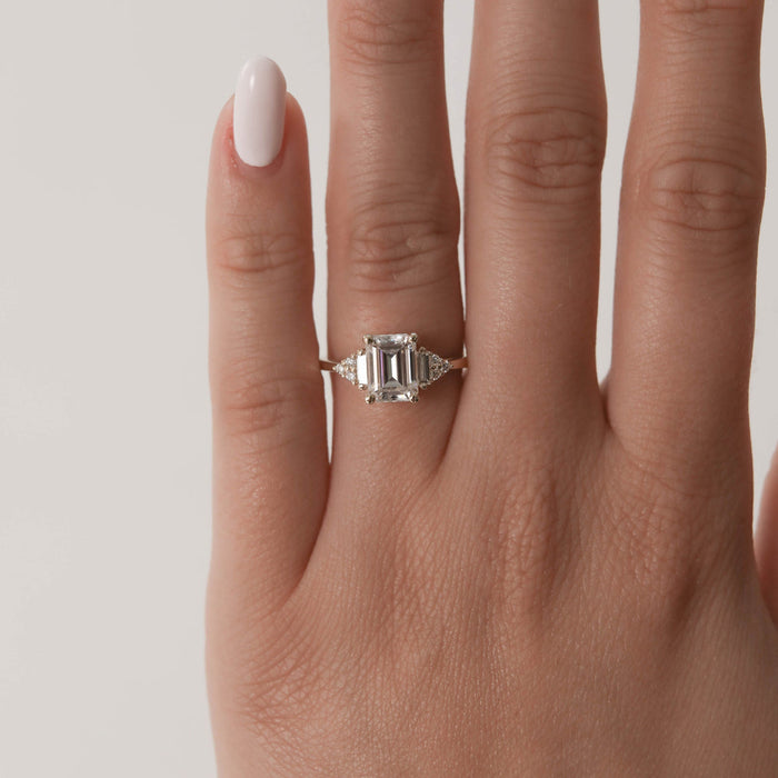 Emerald cut moissanite ring with baguette side stones, side view