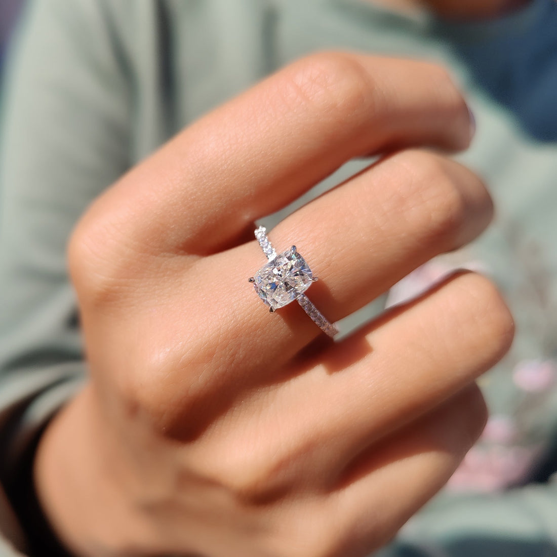 Cushion cut lab grown diamond pave engagement ring seen from the front