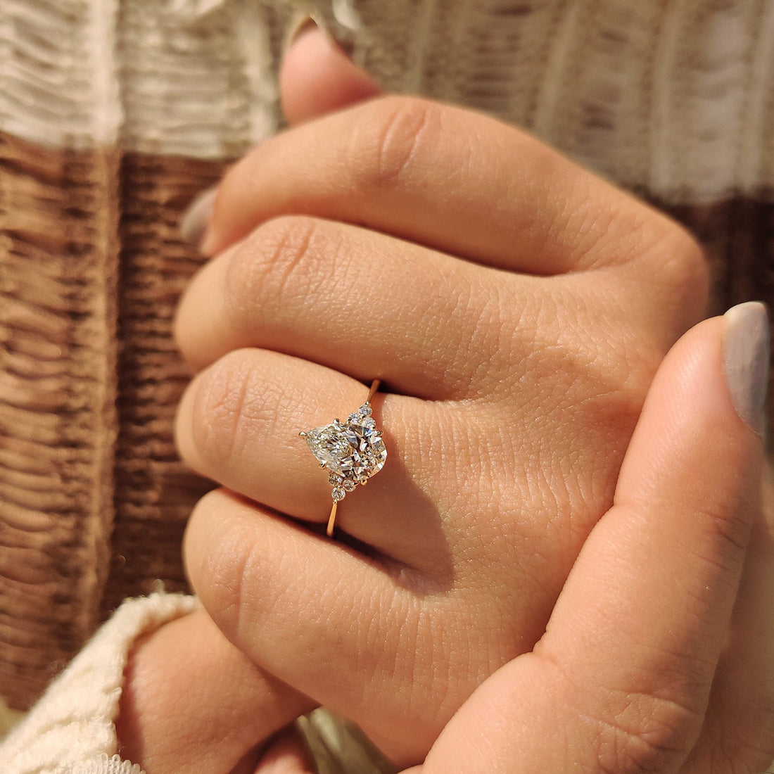 Pear cut lab grown diamond cluster engagement ring seen from the front
