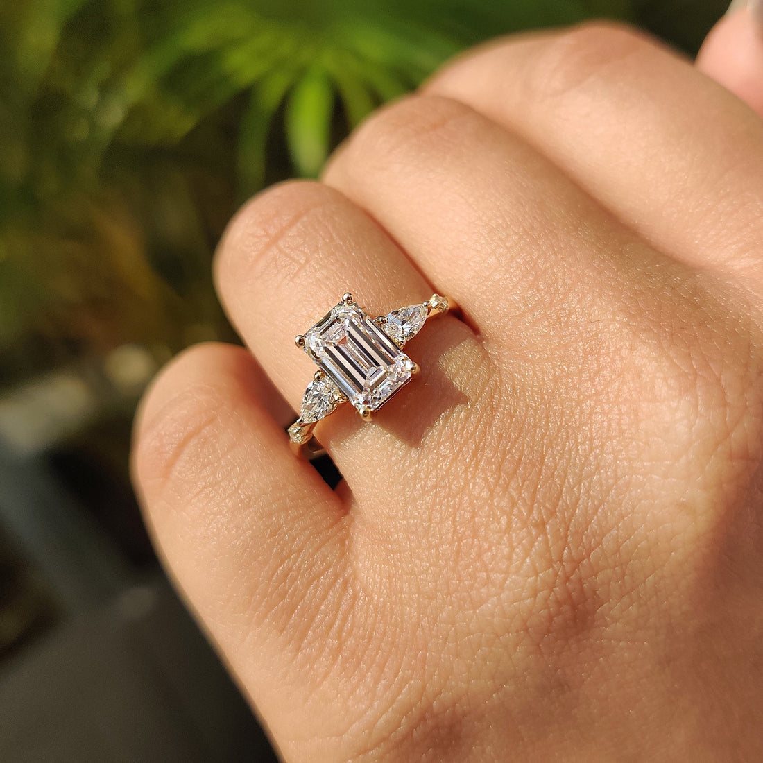 Emerald cut lab grown diamond cluster ring with pear and round accents