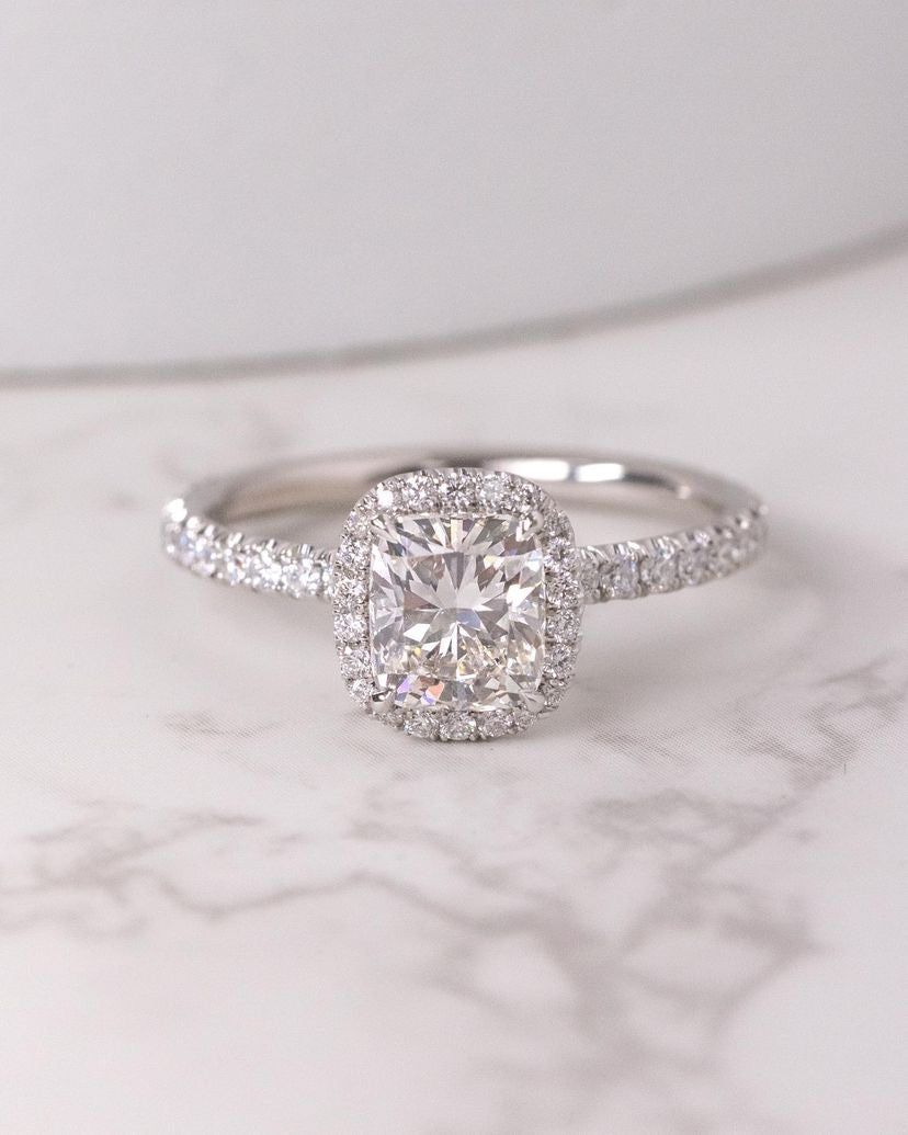 Cushion cut moissanite halo engagement ring in gold