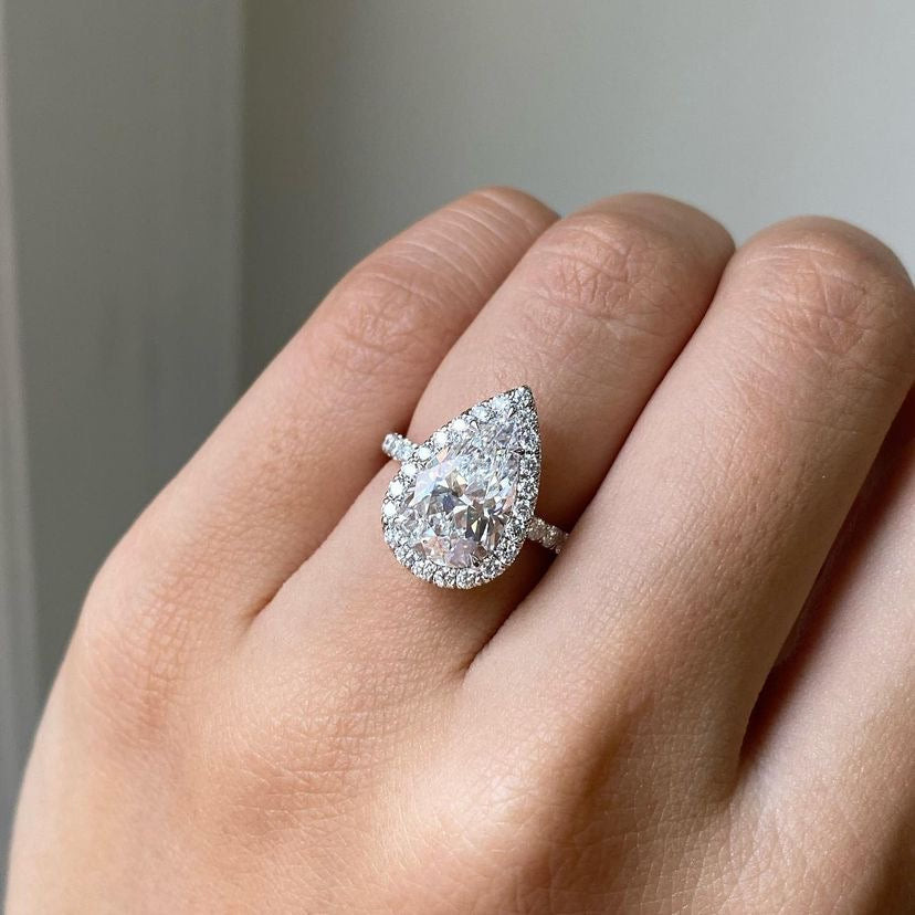 Pear moissanite pave halo engagement ring in gold