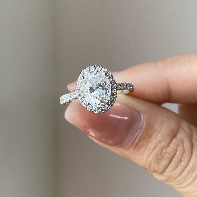 Oval cut moissanite engagement ring with halo in sterling silver