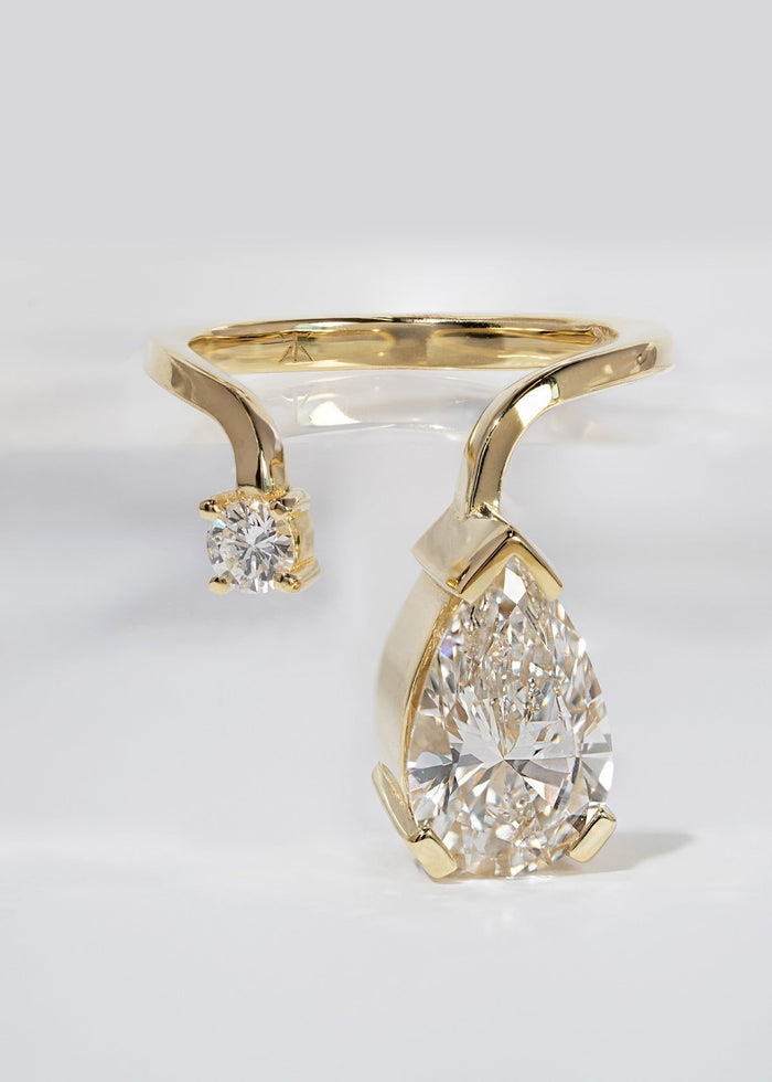 Pear and round cut lab grown diamond drop toi et moi engagement ring in yellow gold