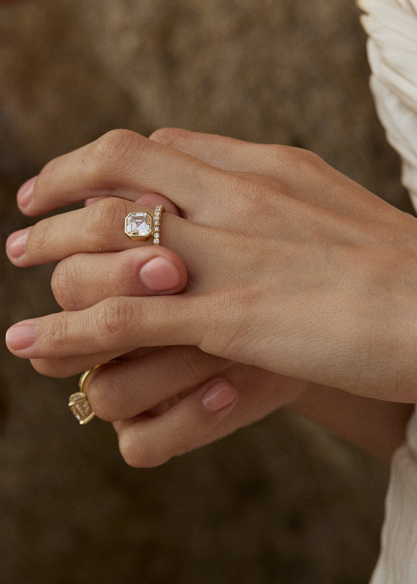 Asscher cut lab grown diamond bezel engagement ring worn on the hand
