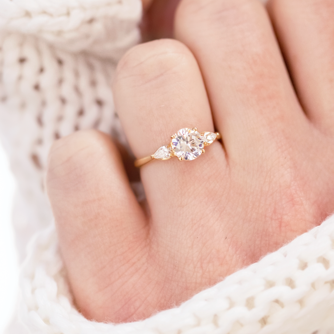 Round Cut Moissanite Three Stone Engagement Ring with Pear Side Stones and Plain Gold Band - view 1