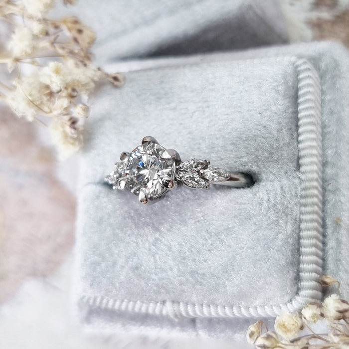 Top view of the round brilliant centre with marquise leaves along each shoulder