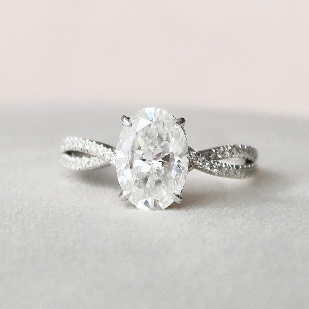 Elongated oval moissanite engagement ring with hidden halo in gold