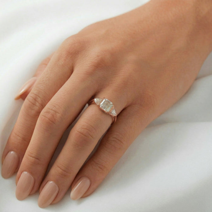 Asscher cut lab grown diamond three stone engagement ring worn on the hand