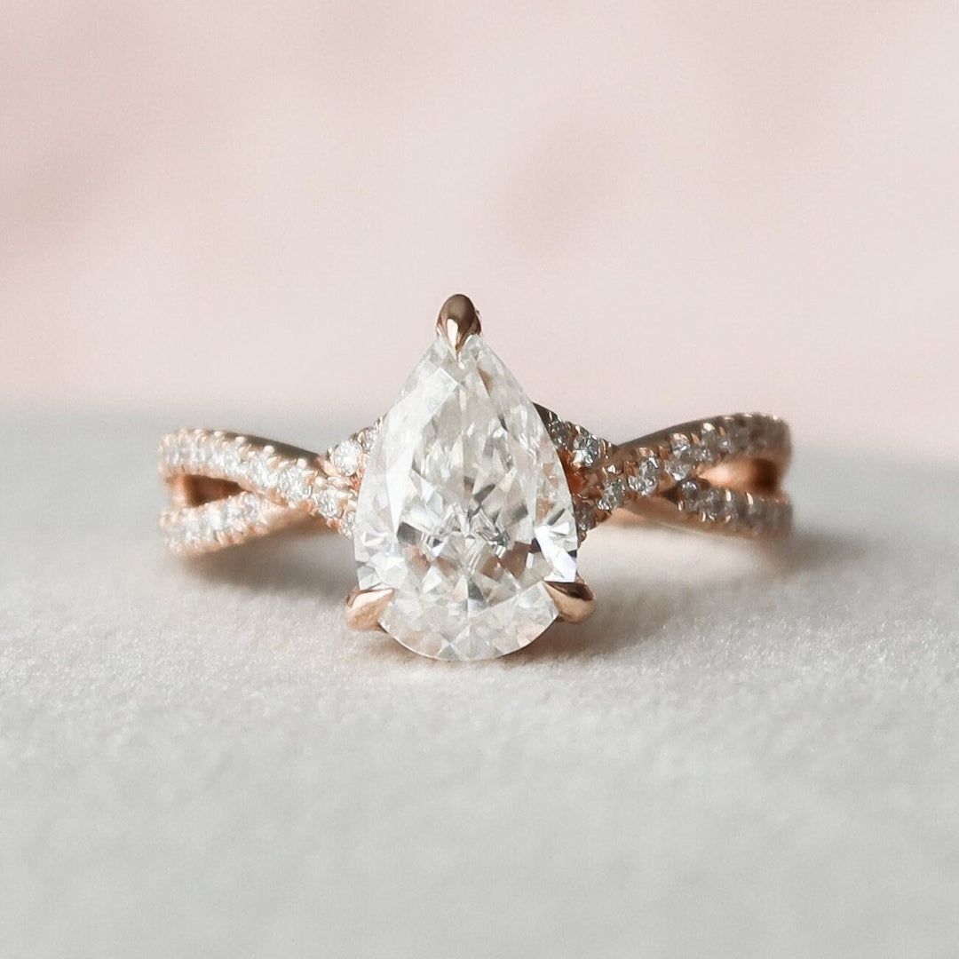 Pear shaped moissanite vintage engagement ring with twisted band in gold