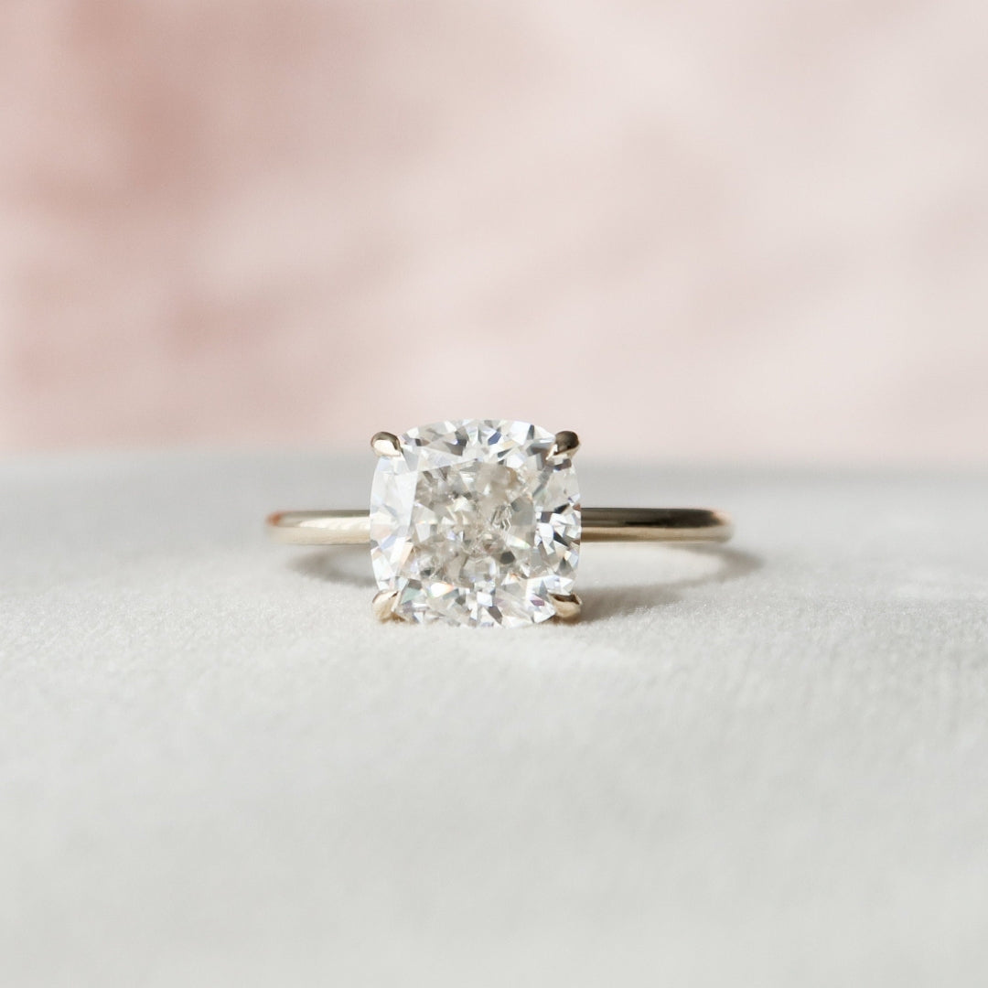 Elongated cushion cut moissanite solitaire engagement ring in gold