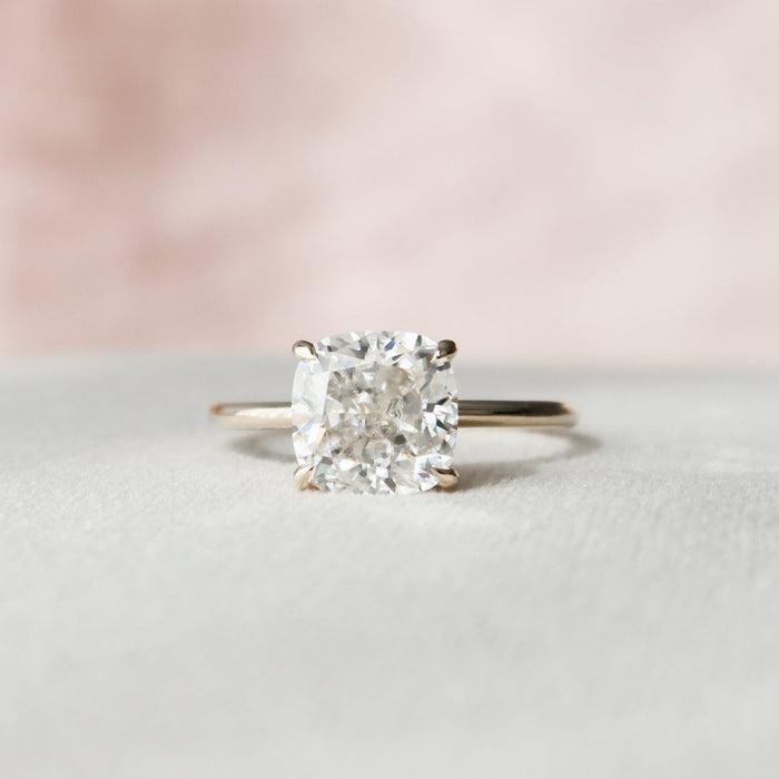 Elongated cushion cut moissanite solitaire engagement ring in gold