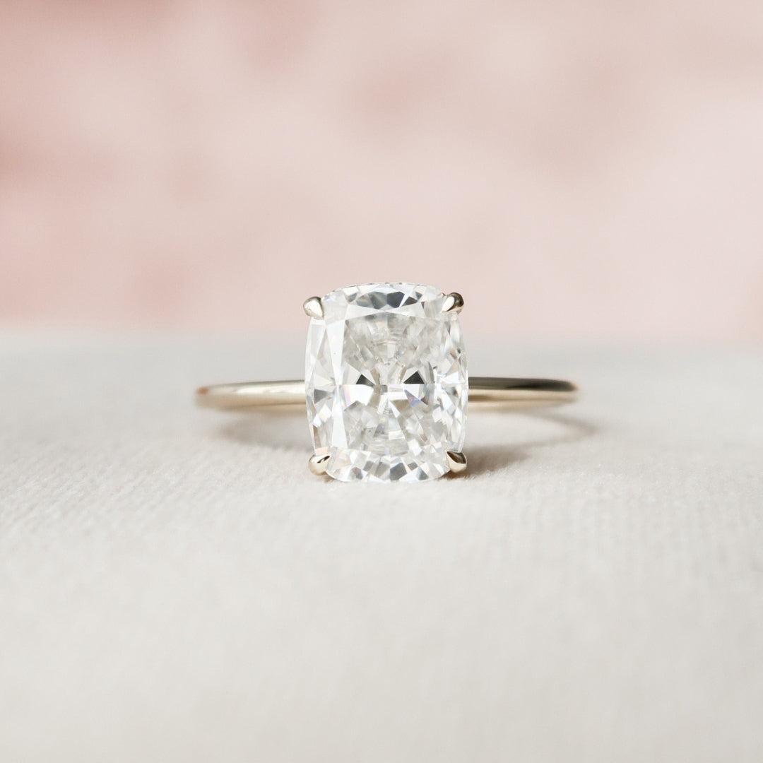 Elongated cushion cut moissanite solitaire engagement ring in gold