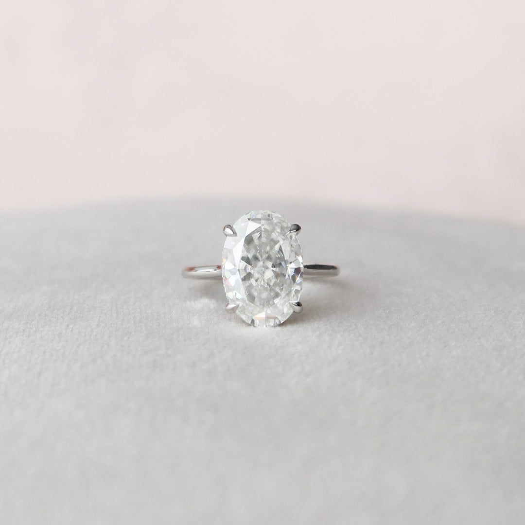 Oval moissanite engagement ring with hidden halo in gold
