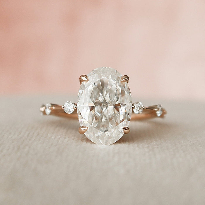 Oval moissanite engagement ring with distance pave band in gold